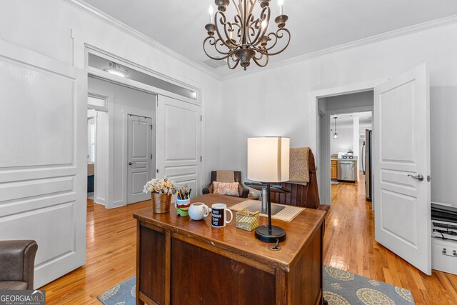 home office featuring a chandelier, visible vents, light wood-style floors, and ornamental molding