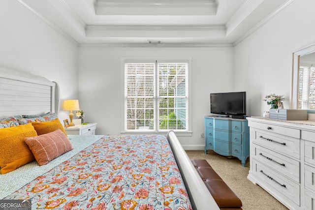 bedroom with light carpet, visible vents, a tray ceiling, and ornamental molding