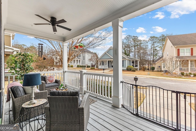 wooden terrace featuring an outdoor living space, a residential view, and a ceiling fan