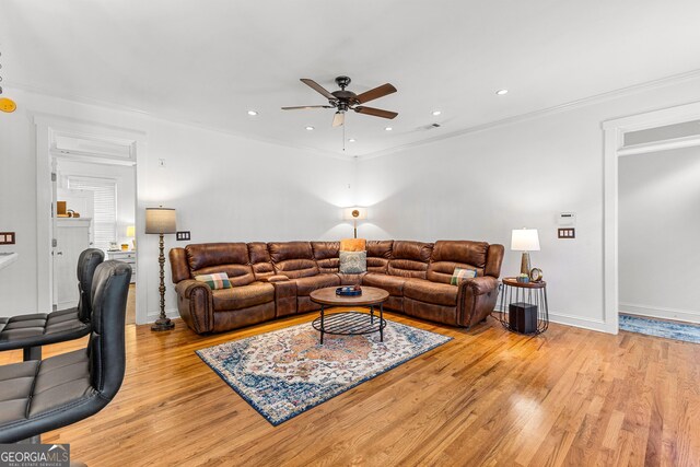 living room featuring light wood finished floors, visible vents, and recessed lighting