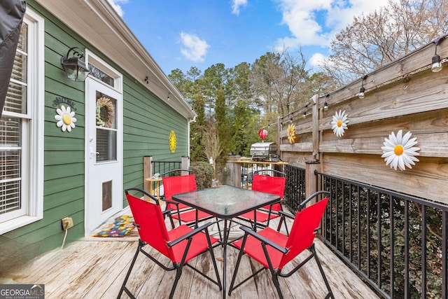 wooden deck featuring outdoor dining space