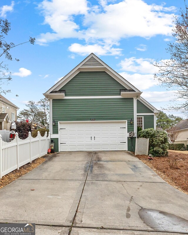 exterior space with fence and driveway