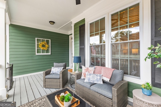 wooden deck with covered porch and outdoor lounge area