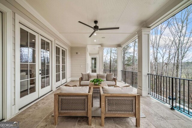 sunroom / solarium featuring ceiling fan