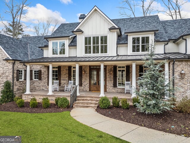 310 Timberview Trl, Alpharetta, GA 30004 - modern inspired farmhouse featuring a chimney, board and batten siding, a porch, brick siding, and a front yard