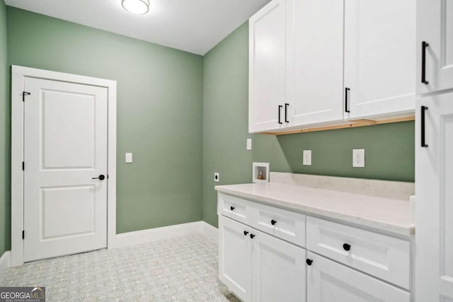 laundry area featuring baseboards, washer hookup, cabinet space, and electric dryer hookup