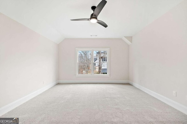 bonus room featuring lofted ceiling, carpet, ceiling fan, and baseboards