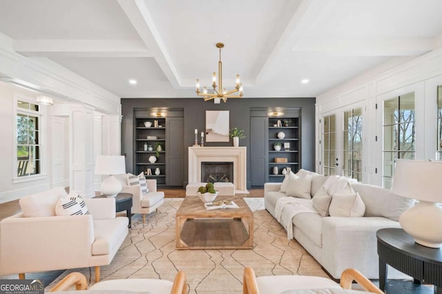 living room featuring coffered ceiling, beamed ceiling, wood finished floors, built in shelves, and a fireplace