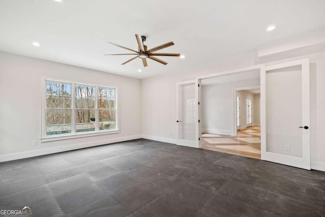 empty room featuring a ceiling fan, recessed lighting, and baseboards