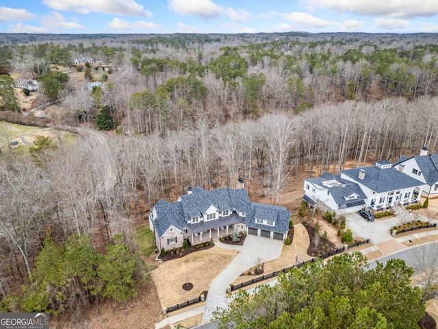 bird's eye view with a wooded view