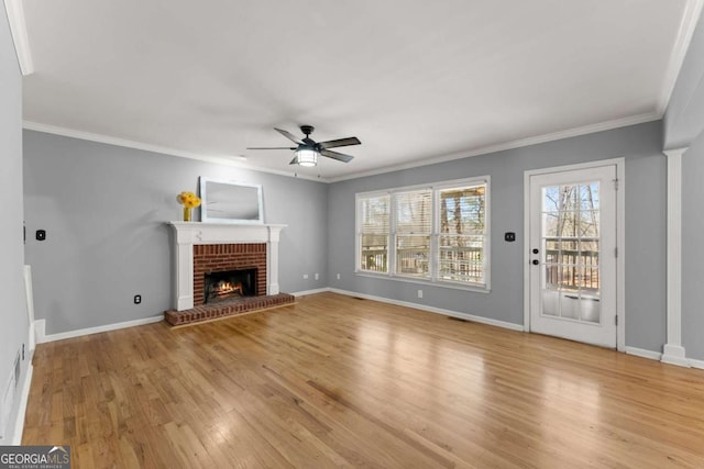 unfurnished living room with light wood-style floors, a fireplace, and baseboards