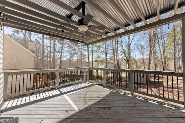 wooden terrace with a ceiling fan