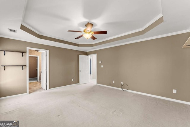 unfurnished bedroom with carpet, a raised ceiling, visible vents, and baseboards