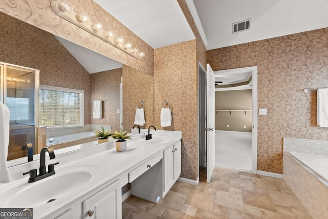 full bath with visible vents, a sink, and wallpapered walls