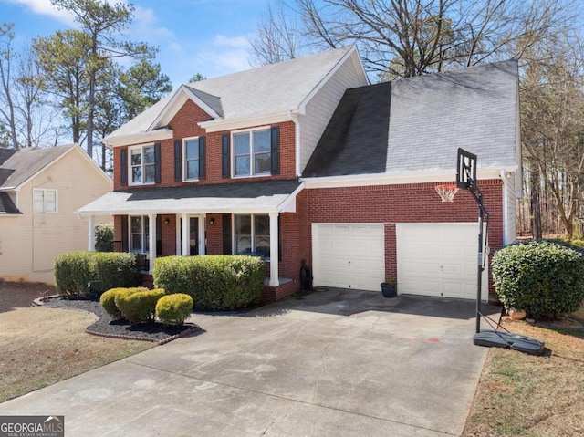 view of front of property featuring an attached garage, concrete driveway, and brick siding