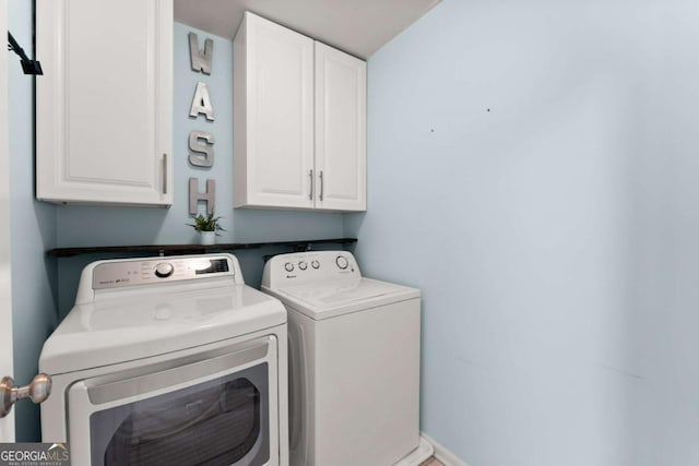 clothes washing area with cabinet space and washer and clothes dryer