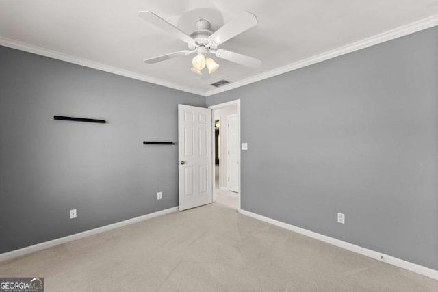 unfurnished room with visible vents, ornamental molding, a ceiling fan, carpet flooring, and baseboards