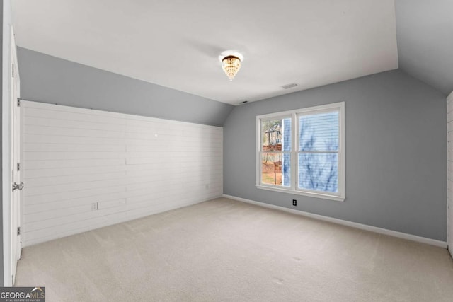 bonus room featuring carpet floors, lofted ceiling, visible vents, and baseboards