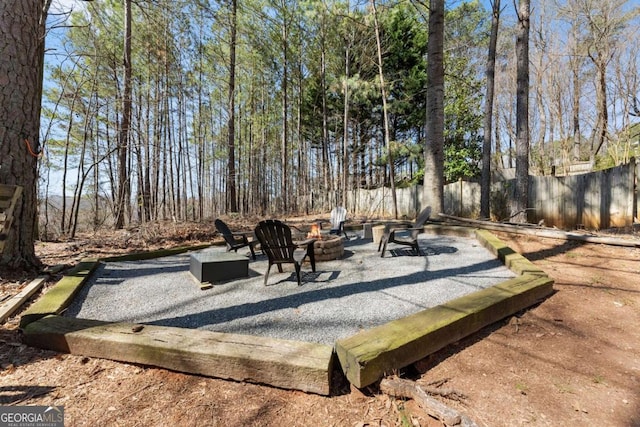 view of patio / terrace with an outdoor fire pit and fence