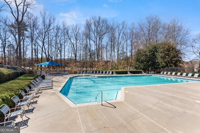 pool featuring a patio area and fence