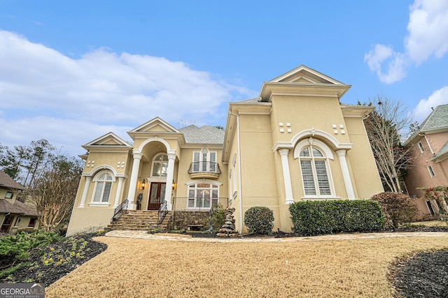 mediterranean / spanish house with french doors and stucco siding