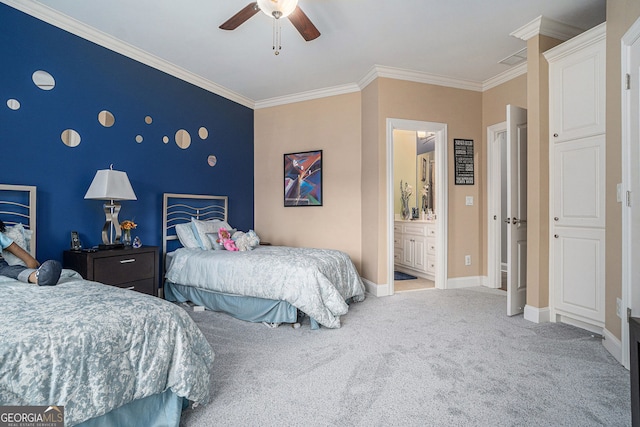 carpeted bedroom with ornamental molding, a ceiling fan, ensuite bath, baseboards, and an accent wall