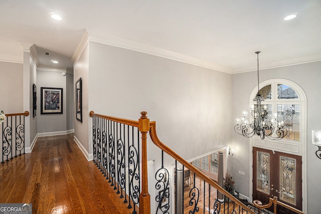 hall featuring an upstairs landing, wood finished floors, recessed lighting, an inviting chandelier, and baseboards