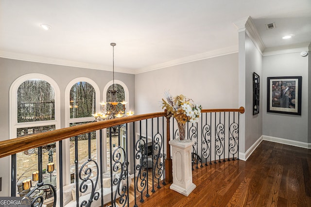 hall featuring baseboards, visible vents, an inviting chandelier, dark wood-style flooring, and ornamental molding