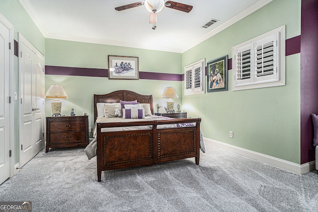 carpeted bedroom featuring visible vents, a ceiling fan, baseboards, and ornamental molding