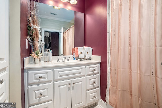 bathroom featuring visible vents, vanity, and crown molding