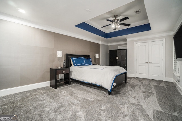 bedroom featuring visible vents, a raised ceiling, ornamental molding, and carpet flooring