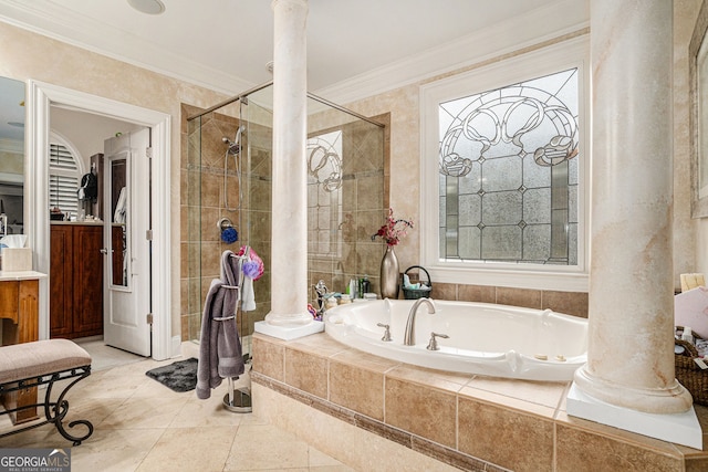 full bathroom featuring crown molding, a garden tub, tile patterned floors, and ornate columns