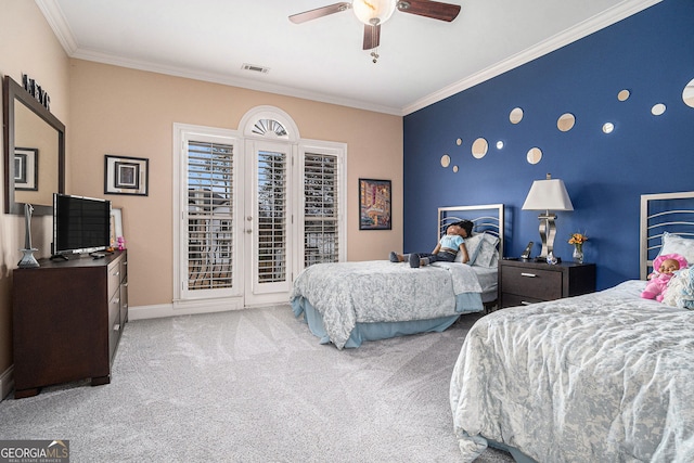 carpeted bedroom featuring visible vents, ornamental molding, baseboards, access to exterior, and an accent wall