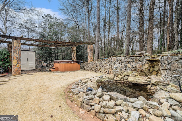 view of yard with a hot tub, a storage shed, and an outdoor structure