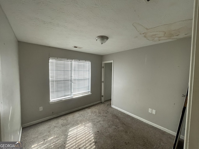 133 Dove Lndg, Social Circle, GA 30025 - unfurnished bedroom with carpet, visible vents, a textured ceiling, and baseboards