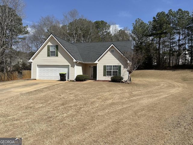 view of front of property with a garage, a shingled roof, and concrete driveway