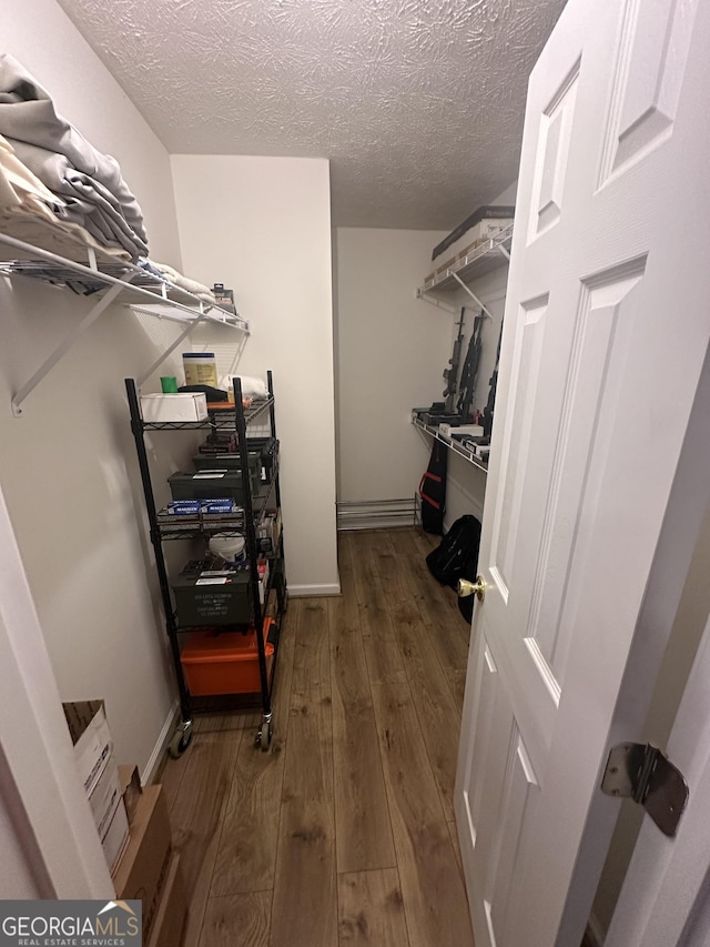 spacious closet featuring hardwood / wood-style flooring