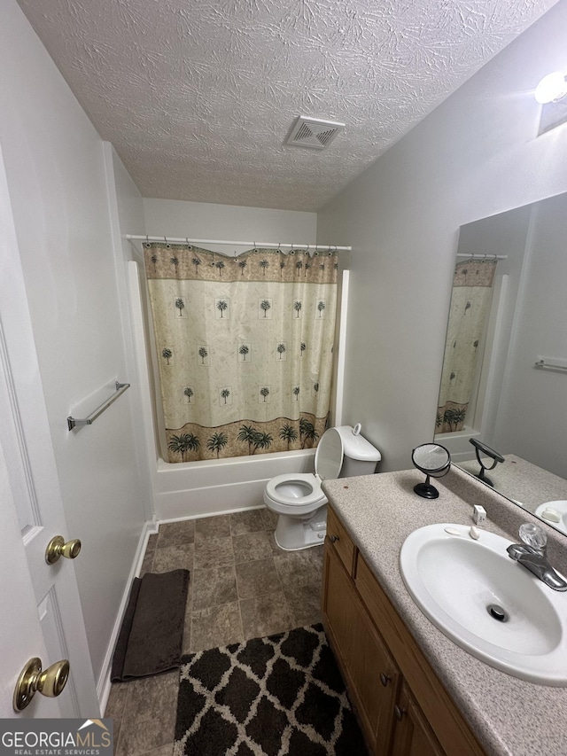 full bath with visible vents, toilet, shower / tub combo with curtain, a textured ceiling, and vanity