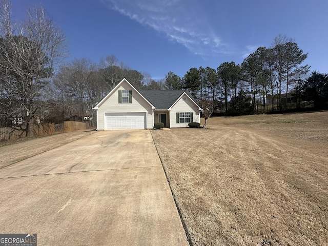 view of front of home with a front lawn and concrete driveway