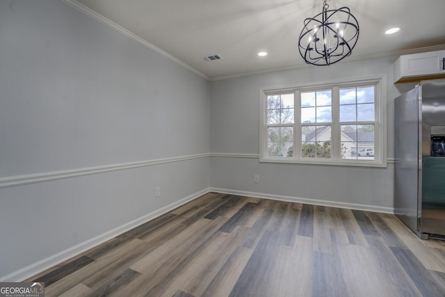 unfurnished dining area with recessed lighting, wood finished floors, visible vents, baseboards, and crown molding