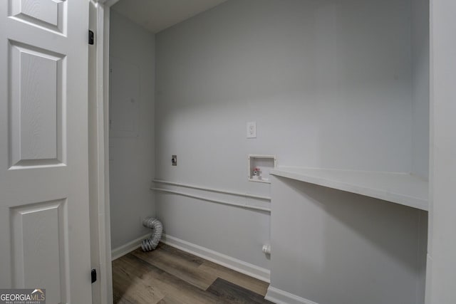 washroom with baseboards, washer hookup, wood finished floors, and hookup for an electric dryer