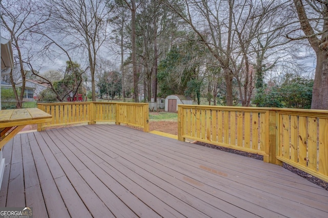 deck with a shed and an outdoor structure