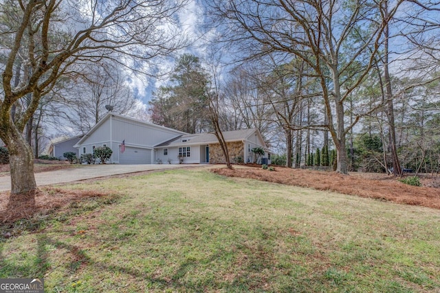 ranch-style home with a garage, driveway, and a front yard