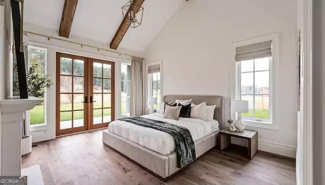 bedroom with high vaulted ceiling, access to exterior, french doors, light wood-type flooring, and beam ceiling