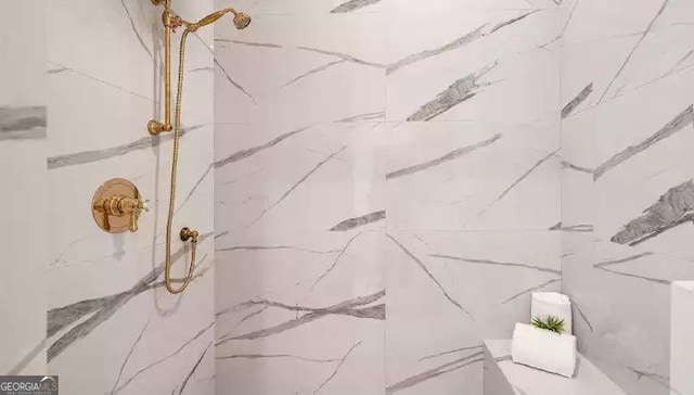 interior space featuring a marble finish shower