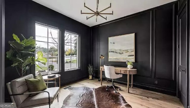 office area featuring a decorative wall and light wood finished floors