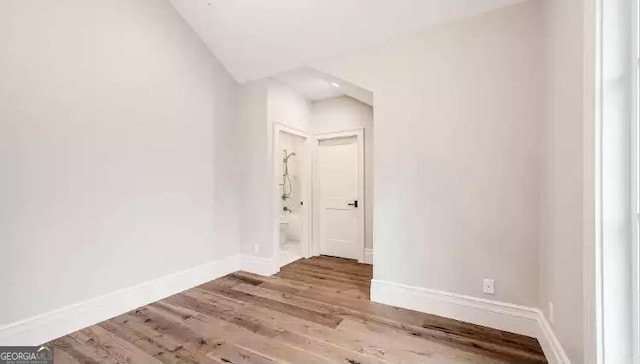 empty room featuring baseboards and wood finished floors