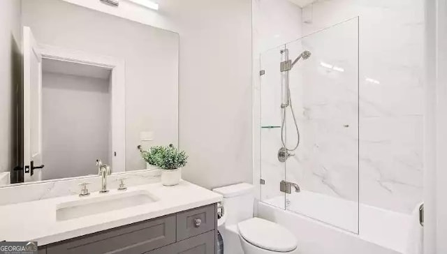 bathroom with shower / washtub combination, vanity, and toilet