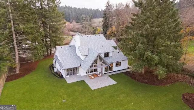 birds eye view of property with a view of trees