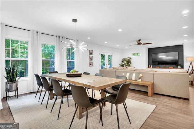 dining space with light wood finished floors, french doors, and recessed lighting